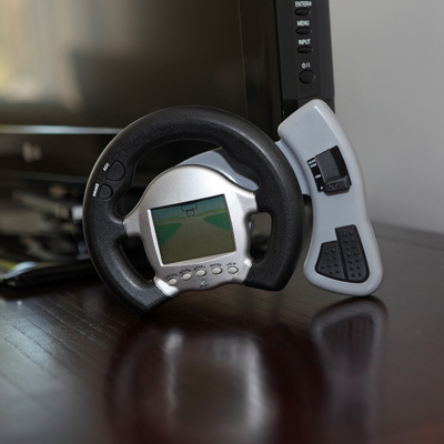 SUNSCOPE® 3-in-1 Car Racing Game - This game features an interactive steering wheel with acceleration, brakes, and realistic gear shift! You can also select 10 different routes and it vibrates on bumps and crashes. Uses 2 AA batteries (not included).